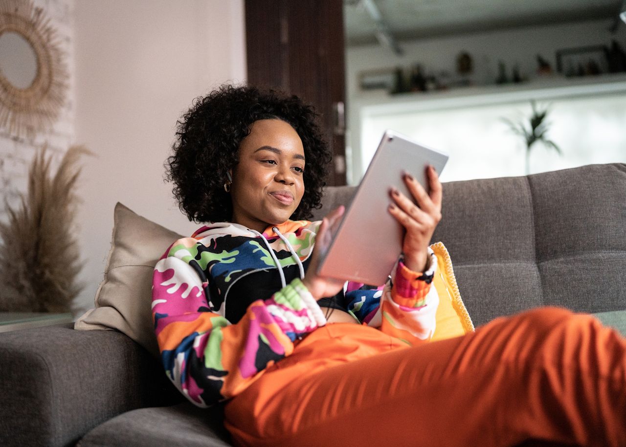 Frau auf Sofa mit Tablet